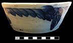 Grey bodied salt glaze stoneware bowl with cobalt decoration. Flat base, sloping sides in a pan form more common before 1860 (Greer 1981:97); Rim diameter: 9.50”, Vessel height: 3.75”.